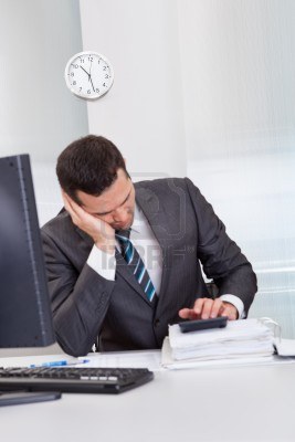 14930815-successful-businessman-sleeping-at-desk-it-the-office